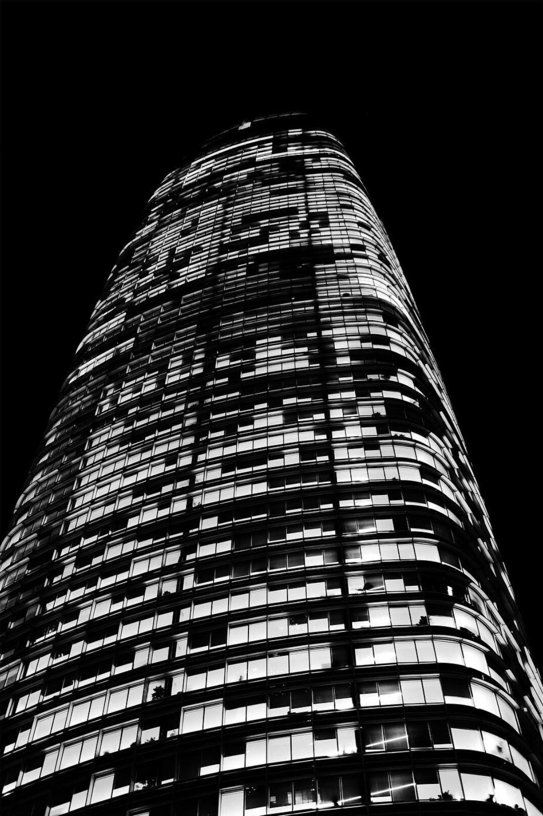 Black and white view looking up Salesforce Tower at night